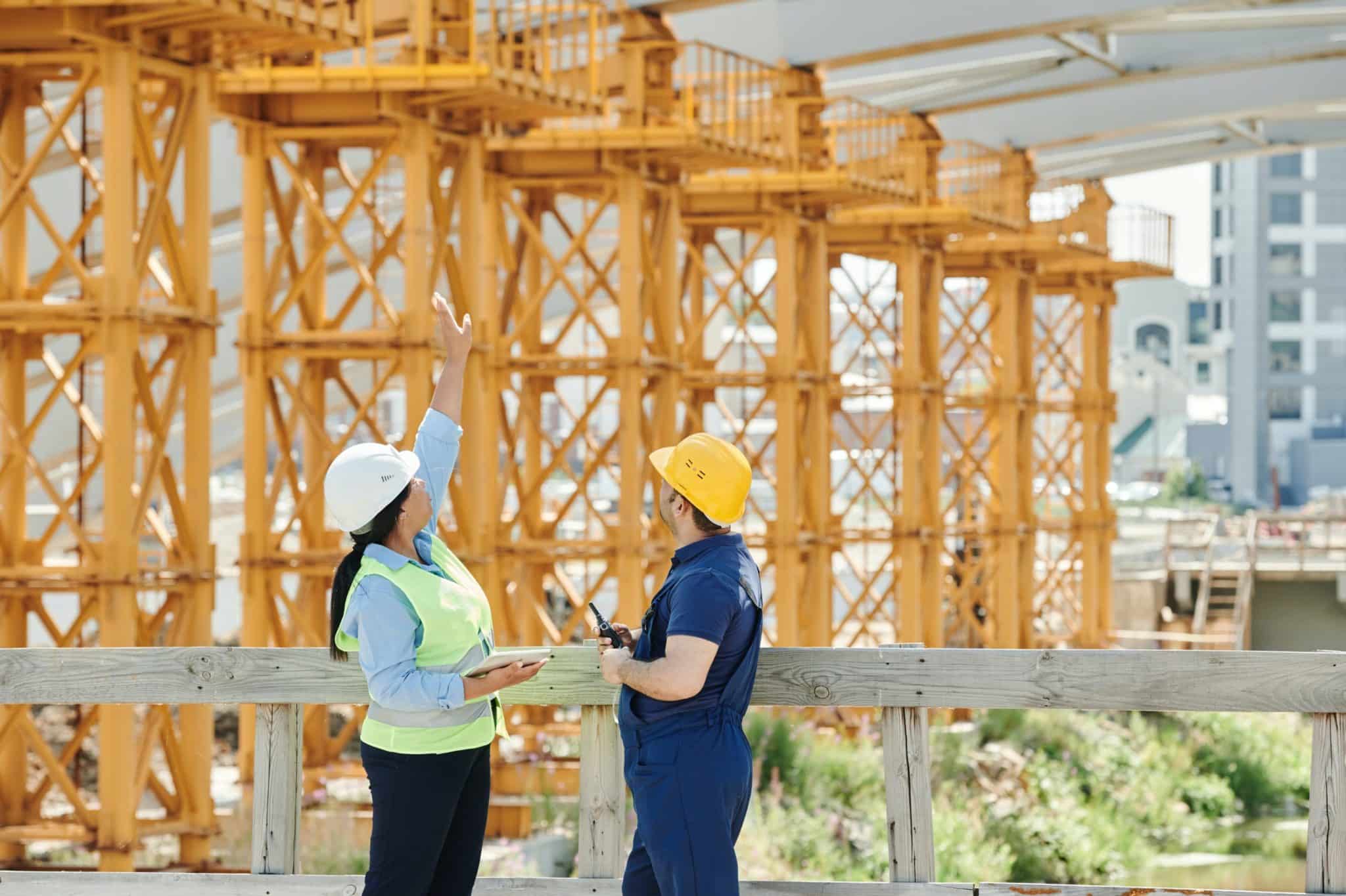 image of construction workers talking in front of a build